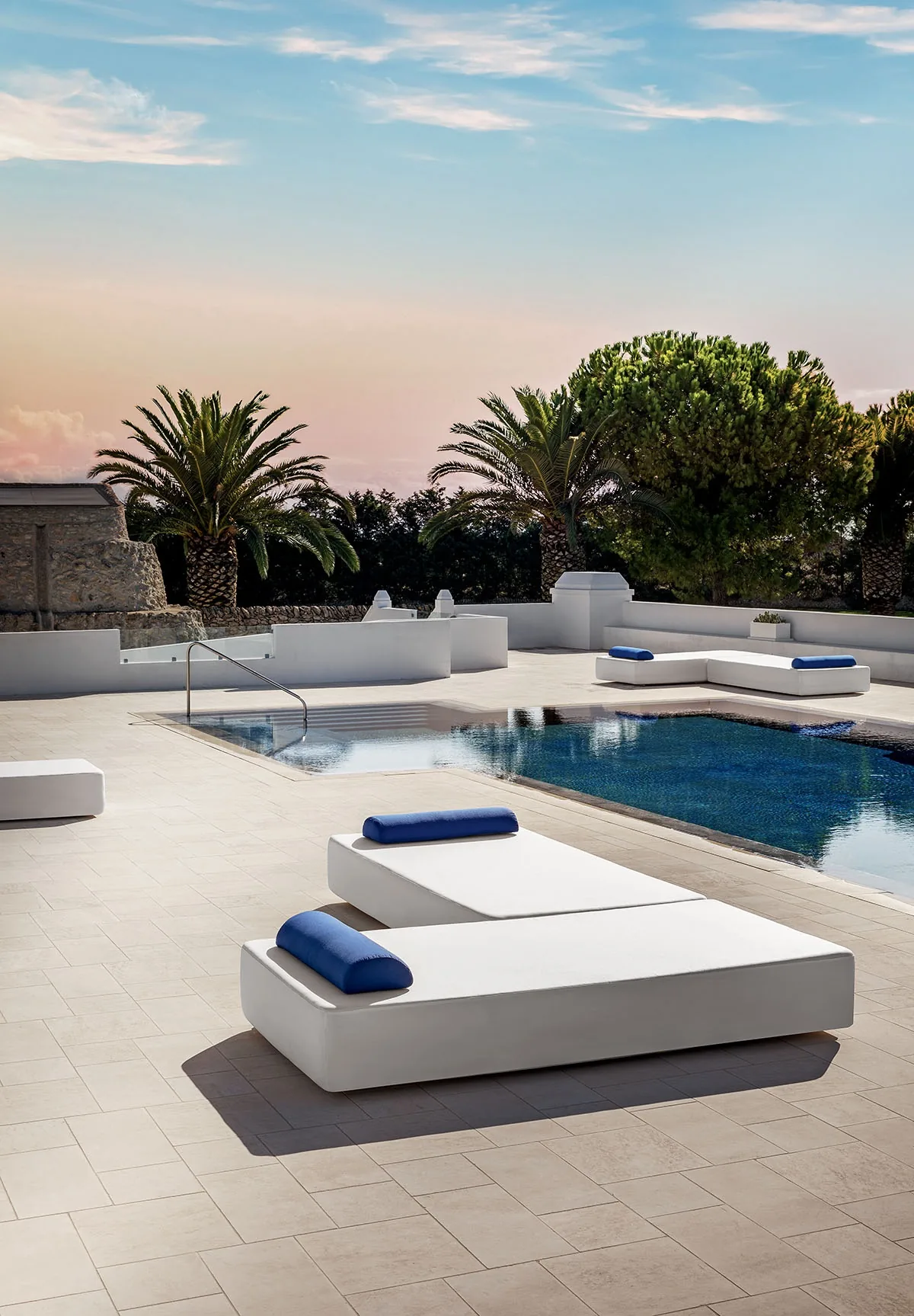 Composizione di lettini modulari Mare bianchi con cuscini blu per area solarium e bordo piscina in hotel di lusso